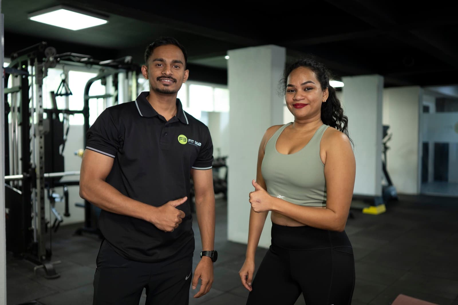 Coach Lucky and a FIT360 client both giving thumbs up after a session